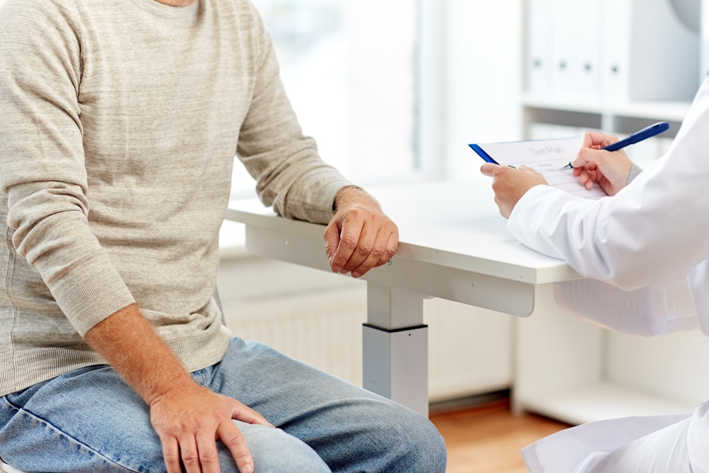 A physician taking notes and talking to a patient in Fairfax, VA
