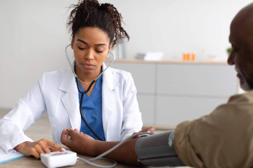 A doctor checking a patient’s blood pressure