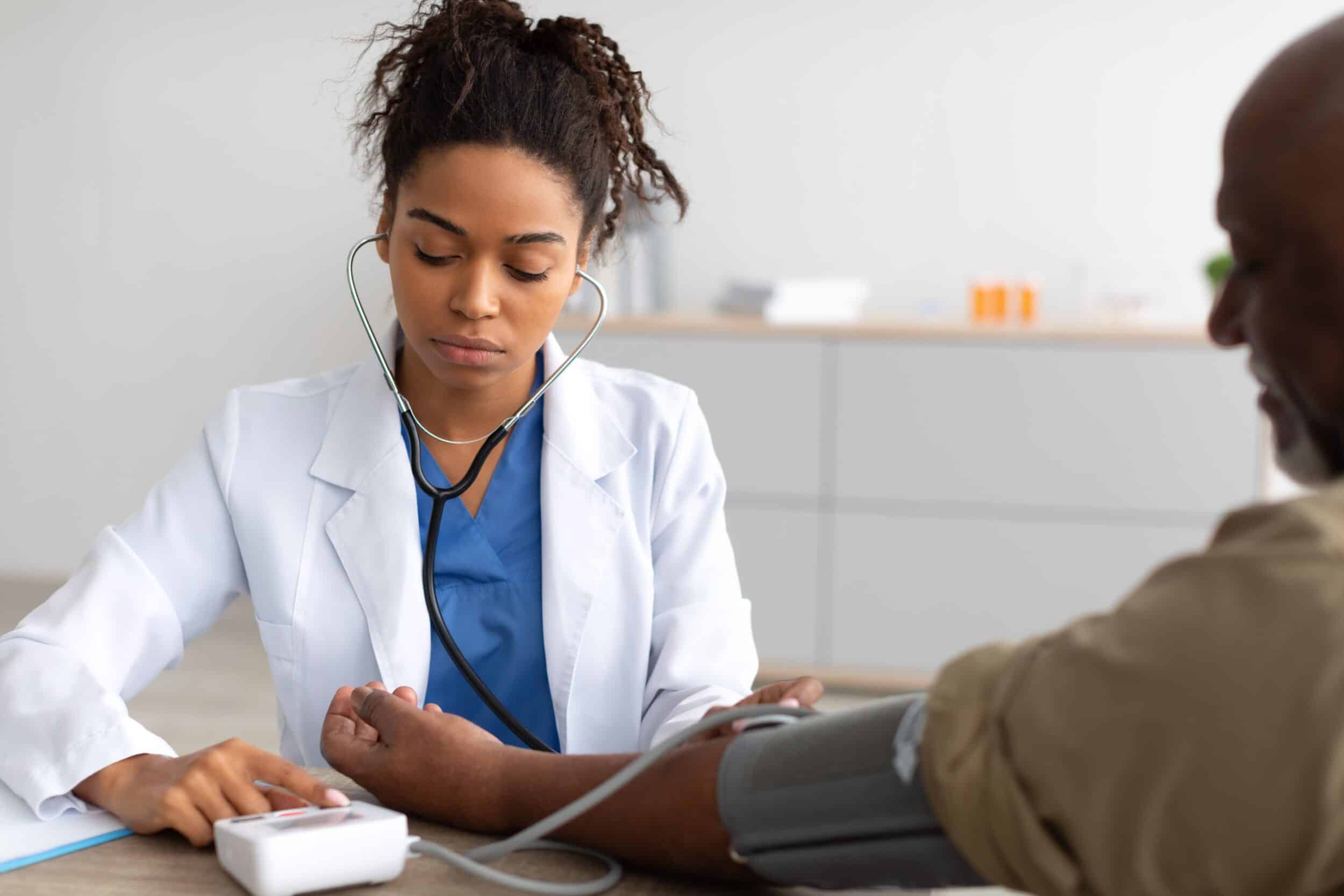 A doctor checking a patient’s blood pressure