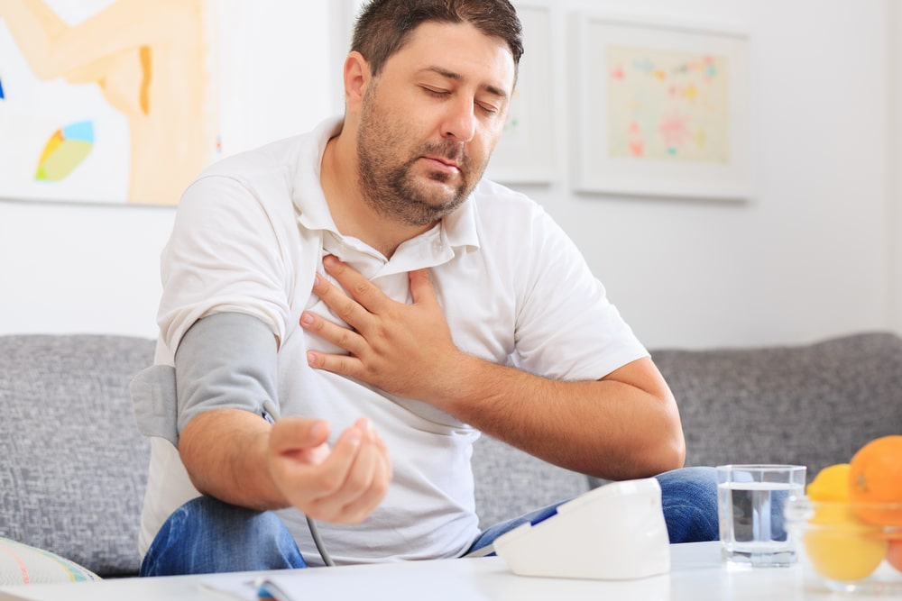 A man with a chronic condition measuring his blood pressure