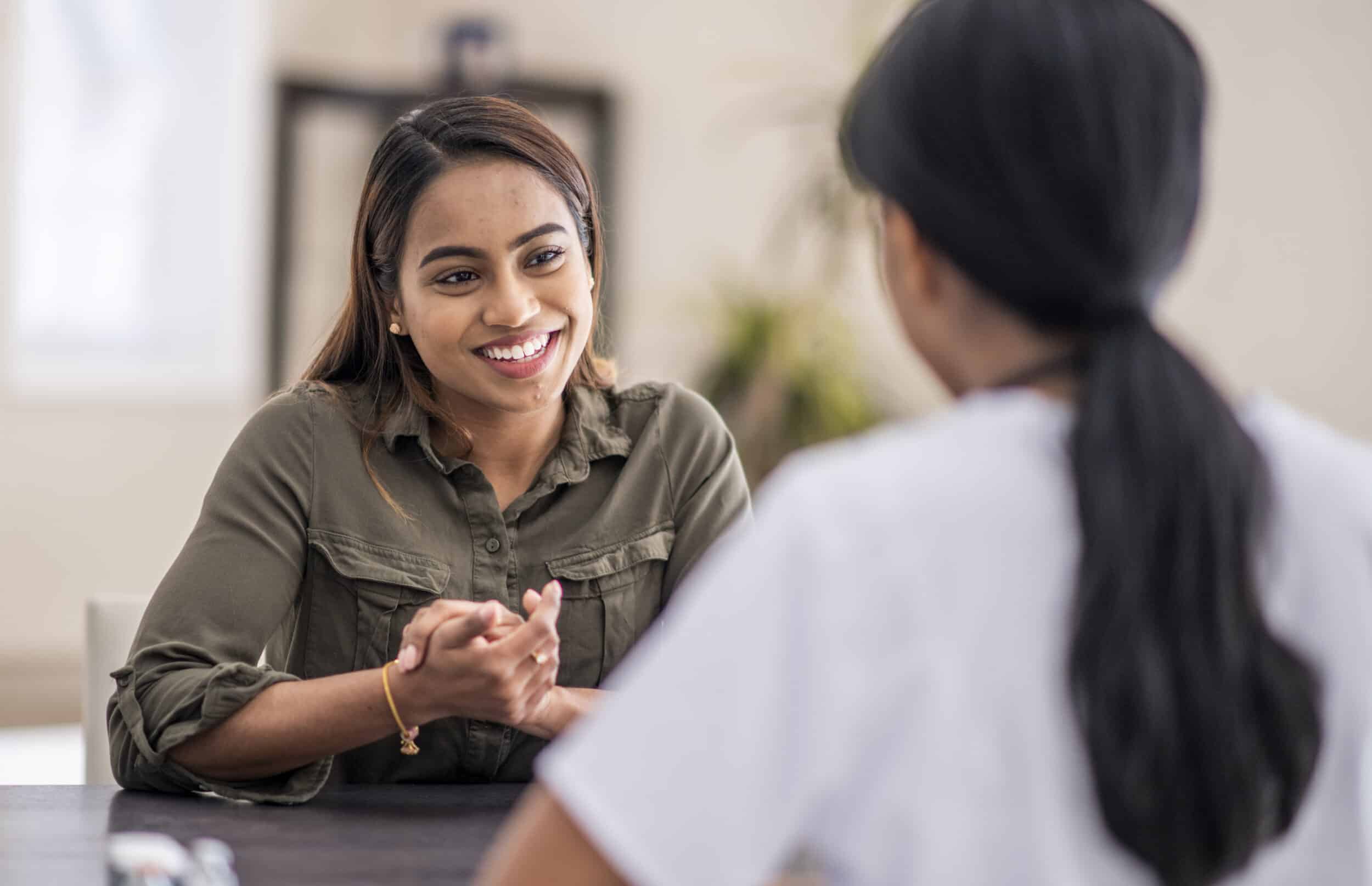 A woman talking to a family medicine doctor in Virginia