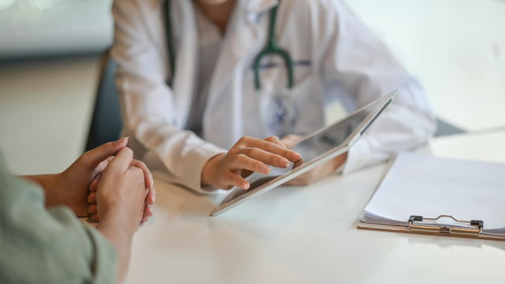 A doctor at a Fairfax family practice talking to a patient