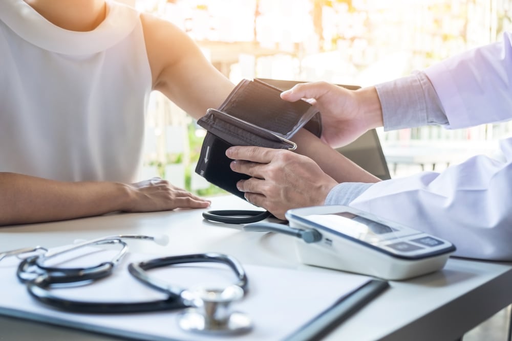 Doctor taking a woman's blood pressure