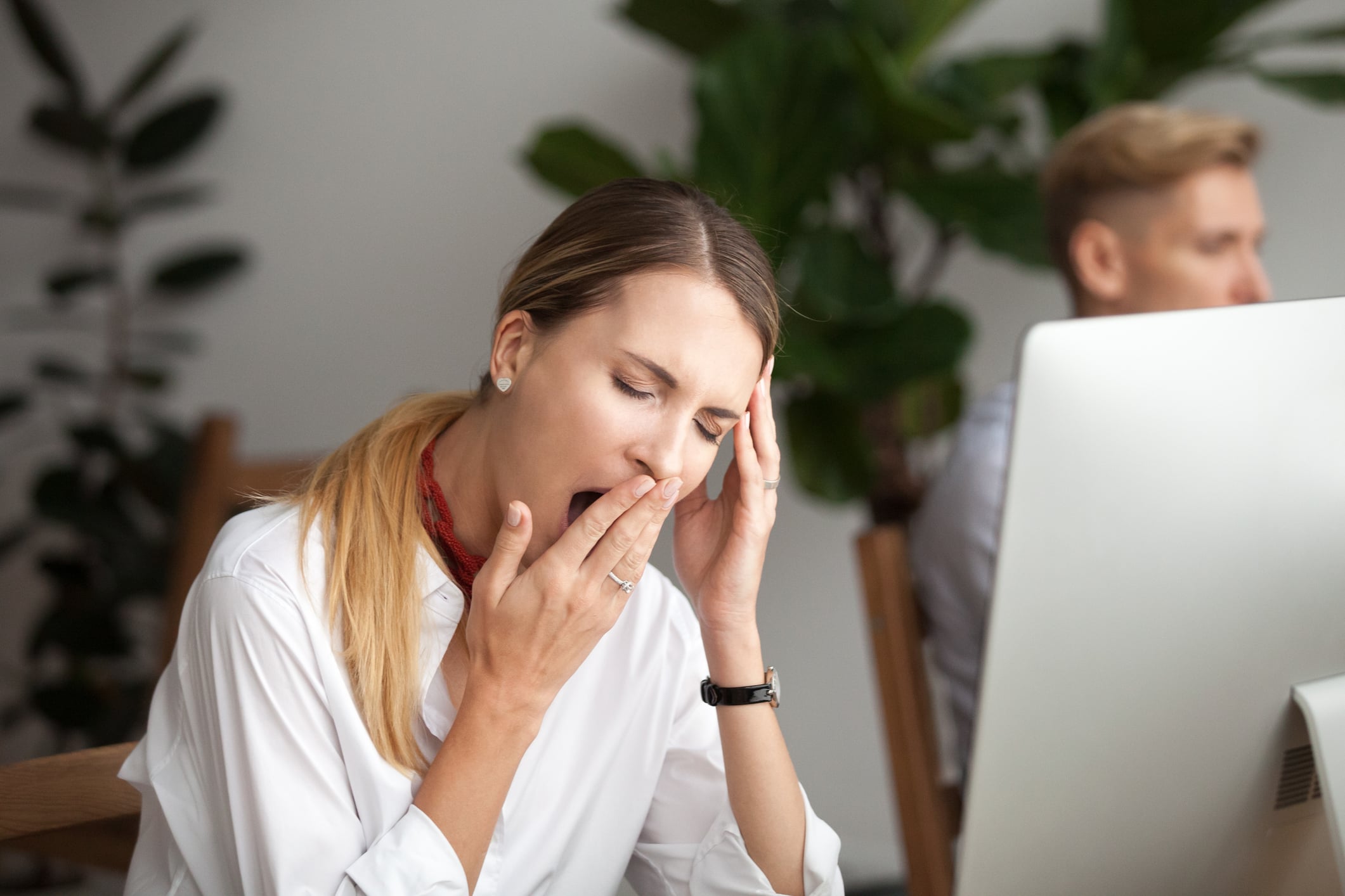 Bored tired businesswoman yawning at workplace feeling lack of sleep Bored businesswoman yawning at workplace feeling no motivation or lack of sleep tired of boring office routine, exhausted restless employee gaping suffering from chronic fatigue or overwork concept
