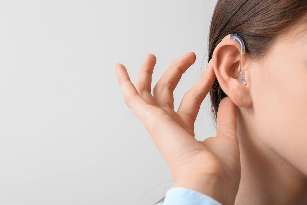A close-up shot of a woman wearing a hearing aid in her ear Hearing Loss Treatment South Riding VA