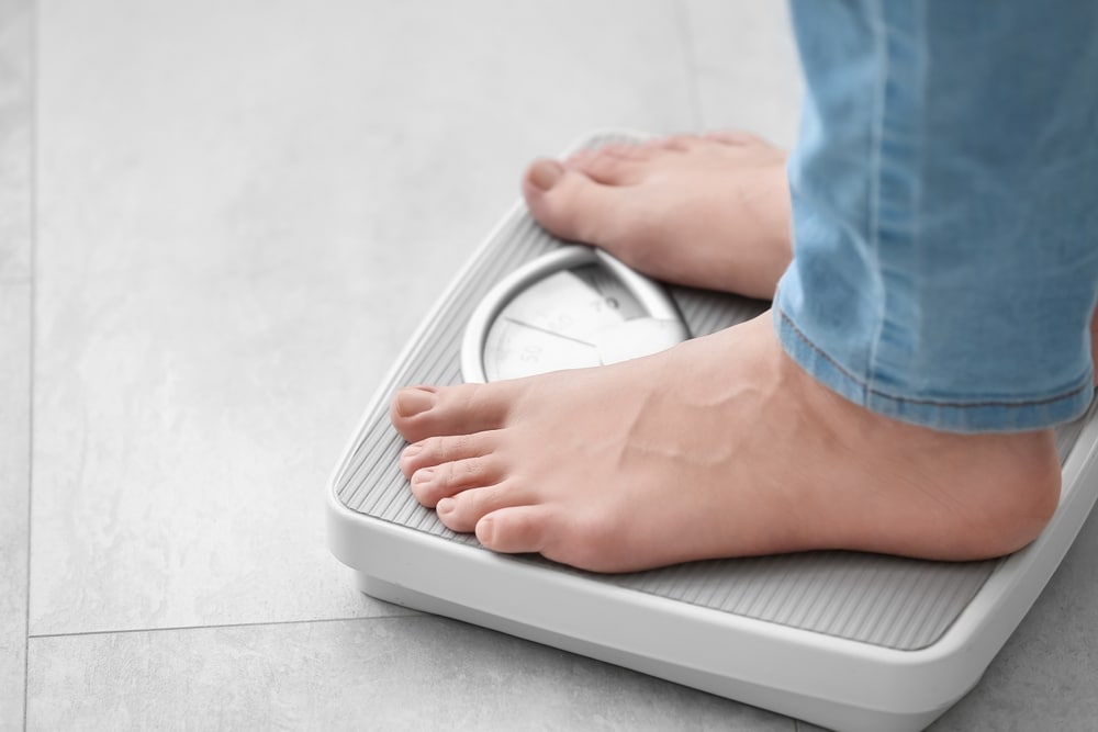 Person standing on scale, interested in semaglutide treatment for weight loss. Semaglutide Merrifield VA