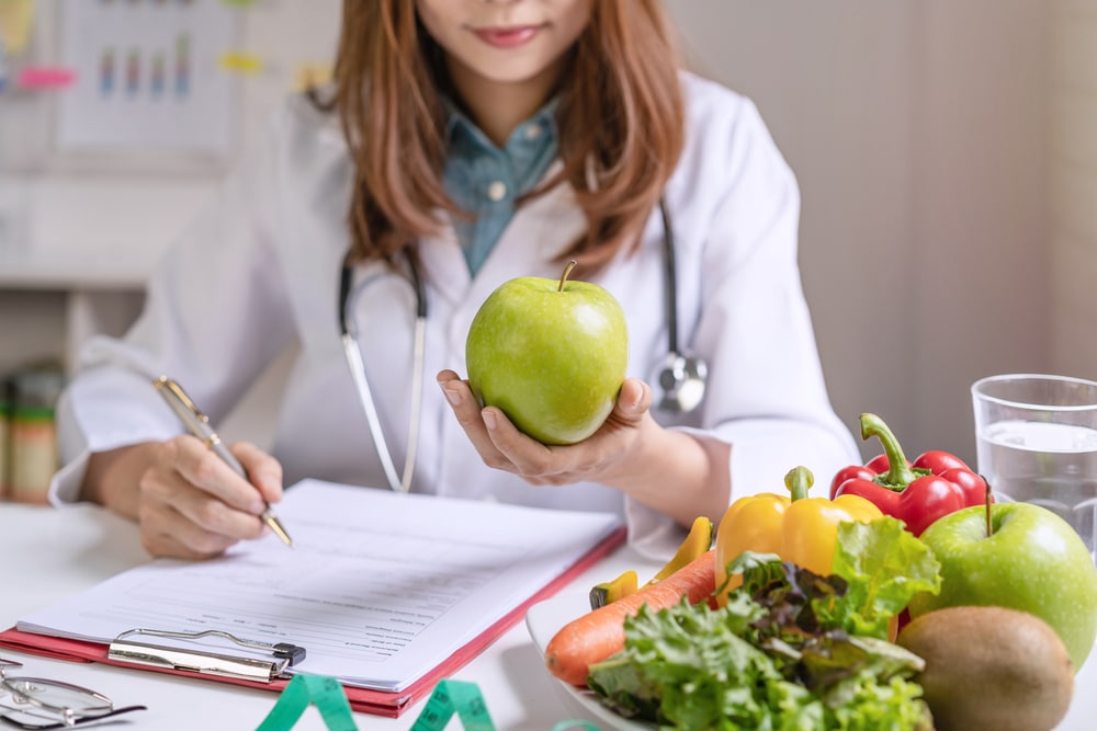 Nutritionist,Giving,Consultation,To,Patient,With,Healthy,Fruit,And,Vegetable, Adolescent Weight Loss in Fairfax, South Riding, Merrifield & Tysons, VA