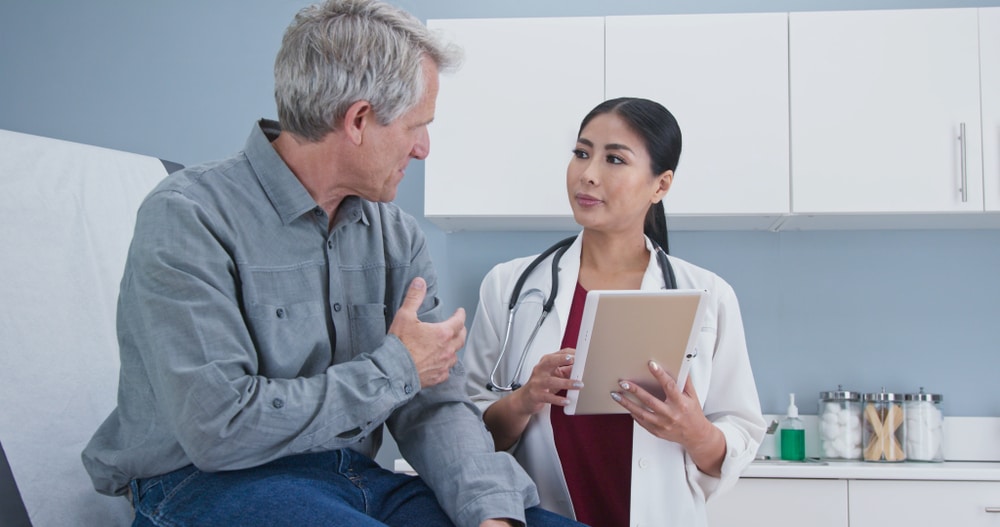 Asian,Woman,Doctor,Talking,Senior,Caucasian,Male,Patient,Sitting,On Types of Care at Prima Medicine in Fairfax, South Riding, Merrifield, & Tysons, VA