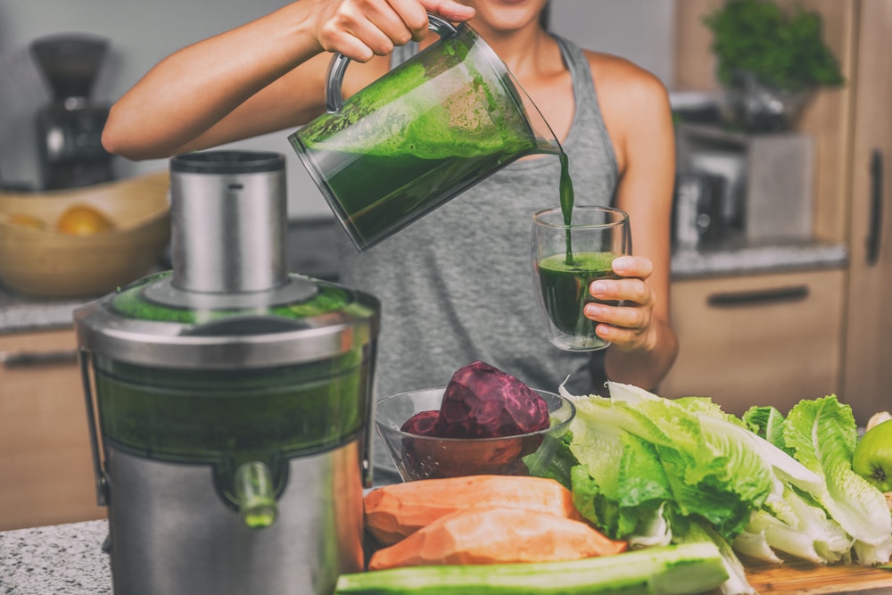 Woman making green juice as part of functional medicine and primary care plan